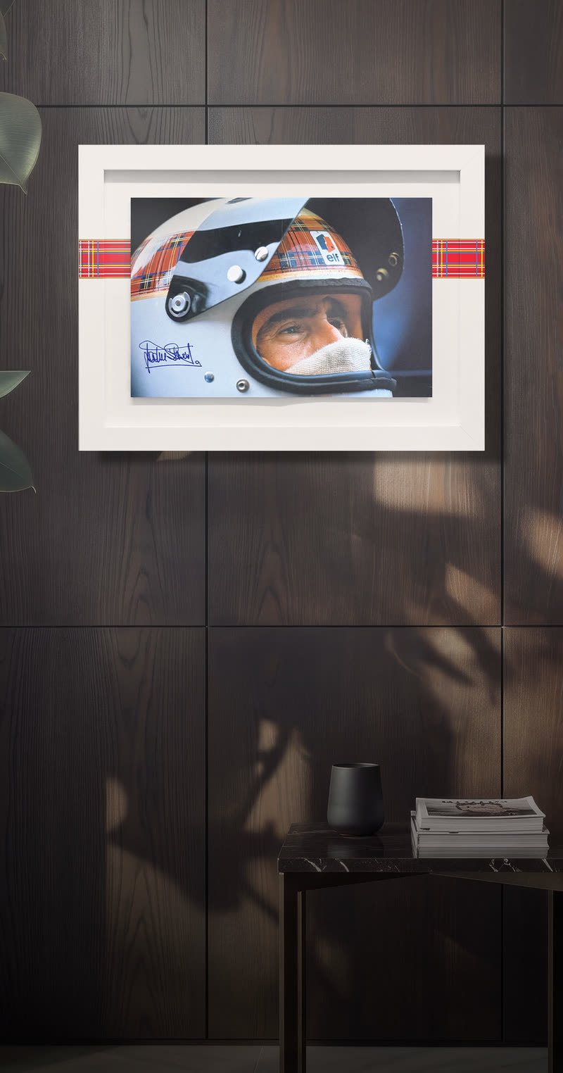 The Jackie-signed edition framed on a dark wood wall
