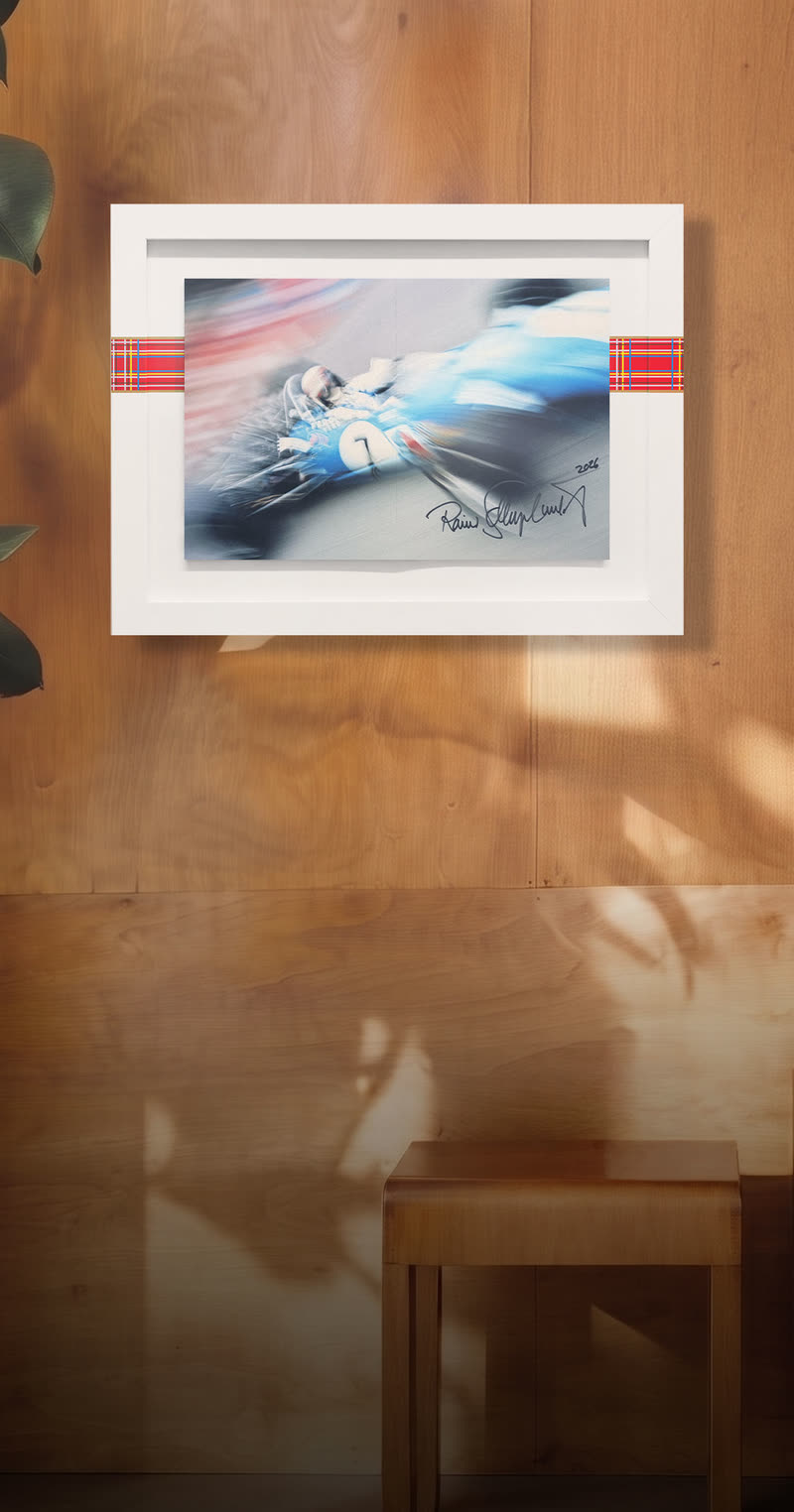 The Rainer-signed edition framed on a warm wood wall