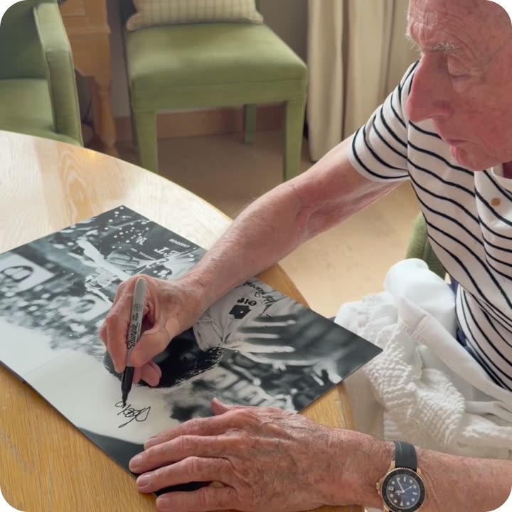 Sir Jackie Stewart signing a Framebook print